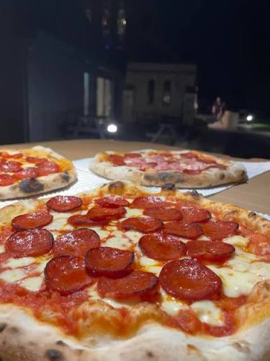 Pepperoni pizzas fresh from the fire